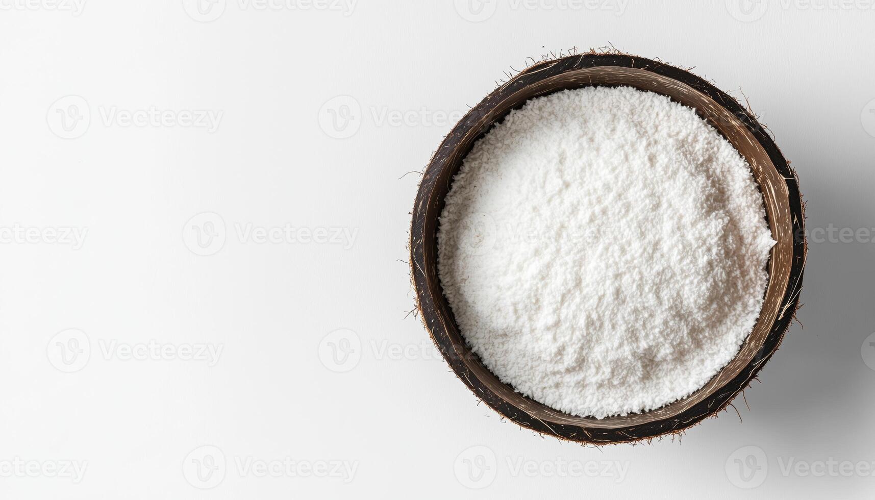 Top View Image Of A Bowl Filled With Fresh Coconut Flour, Placed On A White Surface. Rich In Nutrients And Perfect For Baking. photo