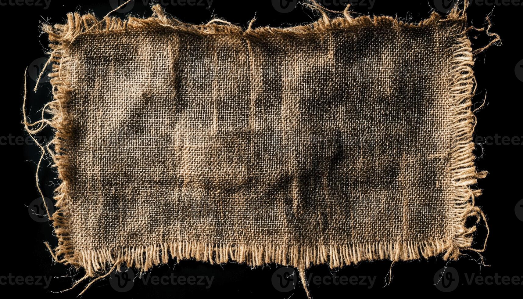 Close Up Of Vintage Burlap Napkin With Rough Texture And Jute Material On Black Background. Hessian Cloth Tag With Frayed Edges. Dark Sack Material photo