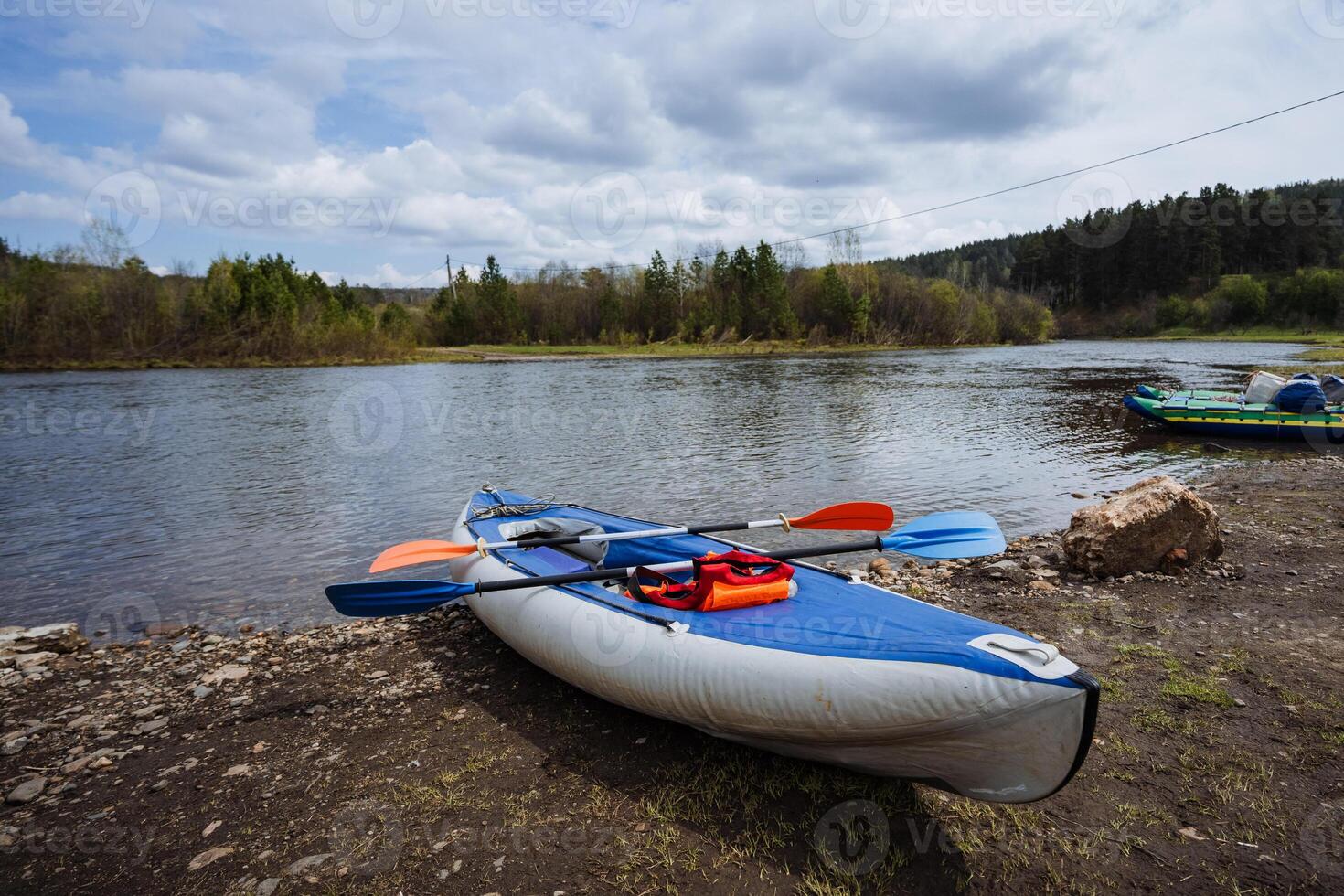 Experience the serene beauty of kayaking on the banks of a tranquil river that flows gently amidst lush greenery and captivating nature, inviting you to explore the great outdoors photo