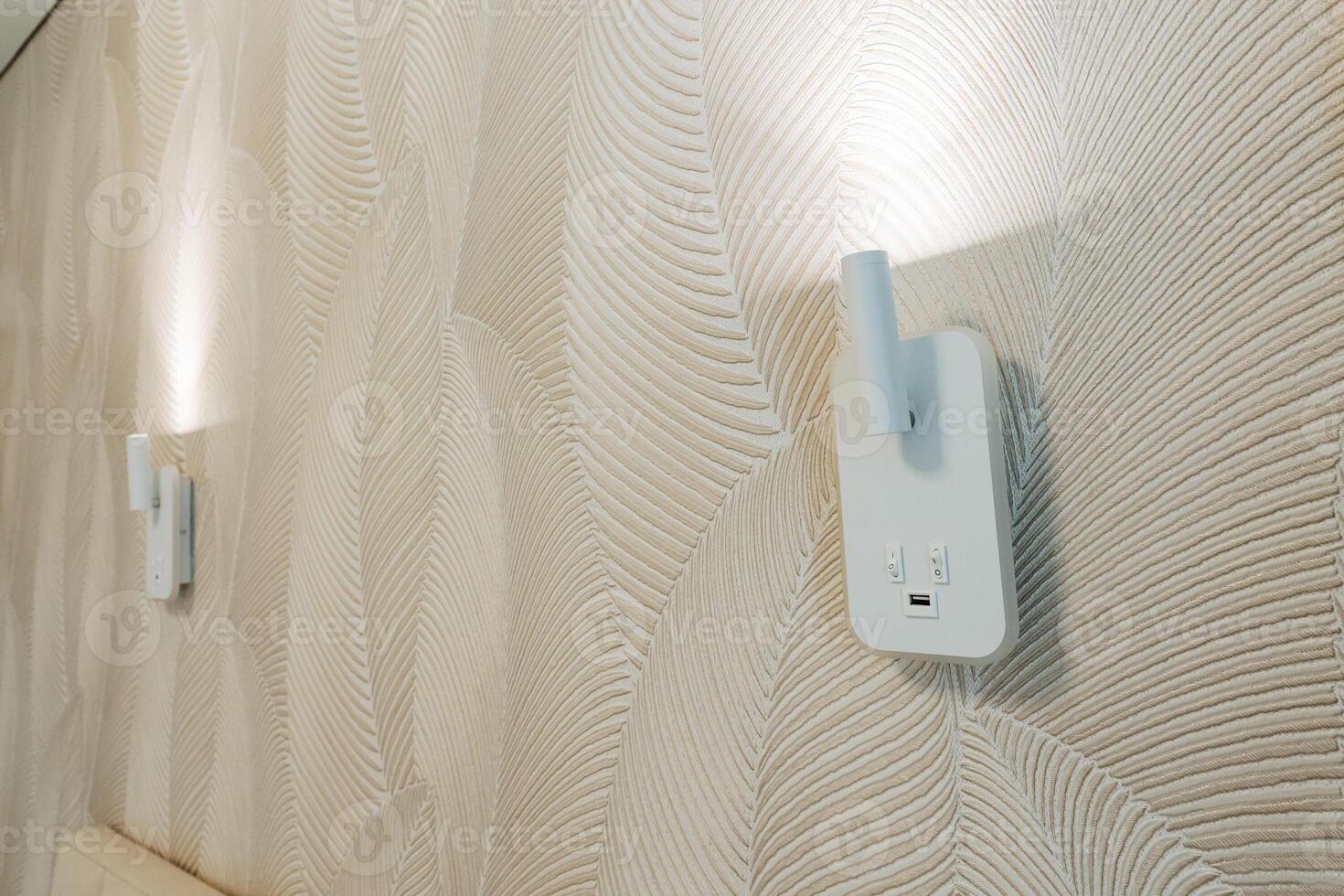 Two beautifully designed wallmounted lights offer gentle, soft illumination that enhances the overall ambiance, creating a warm, inviting, and welcoming atmosphere throughout the space photo