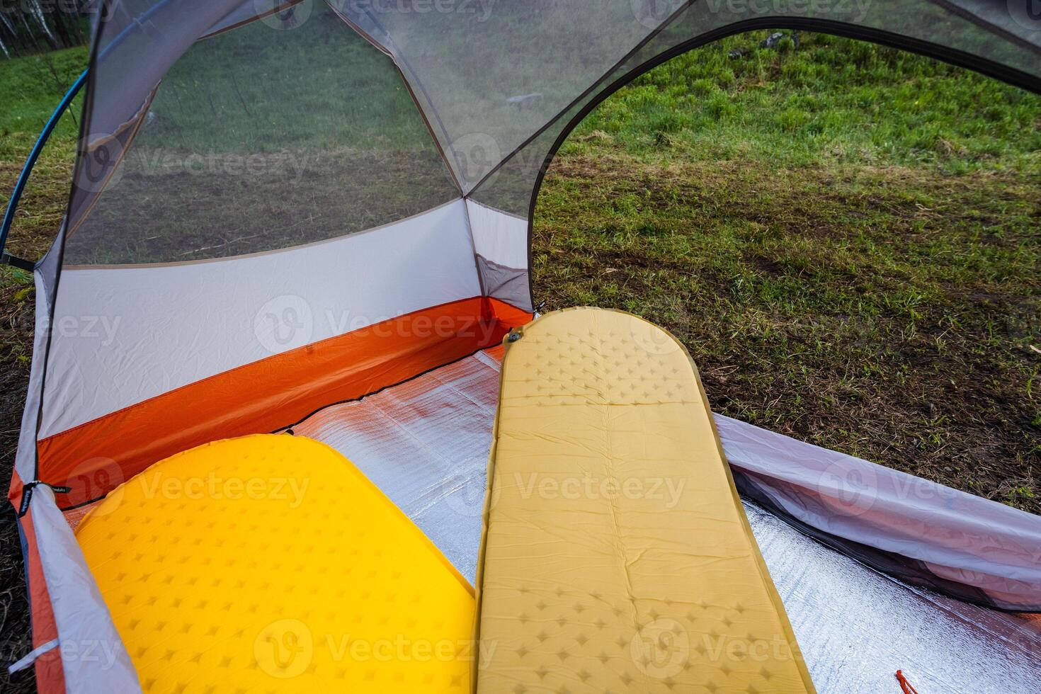 The Cozy Camping Tent Interior has soft air mattresses for comfort, ideal for relaxing during outdoor adventures. Enjoy scenic nature while camping, exploring, and hiking this summer photo