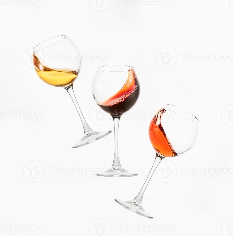 Wine of different colors, varieties splashes in stemware. photo