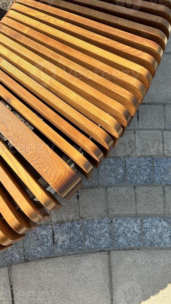 wooden round bench made of slats on the street, top view photo