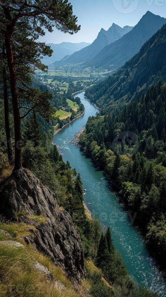 Scenic view of a winding river surrounded by mountains under a clear sky in daylight photo