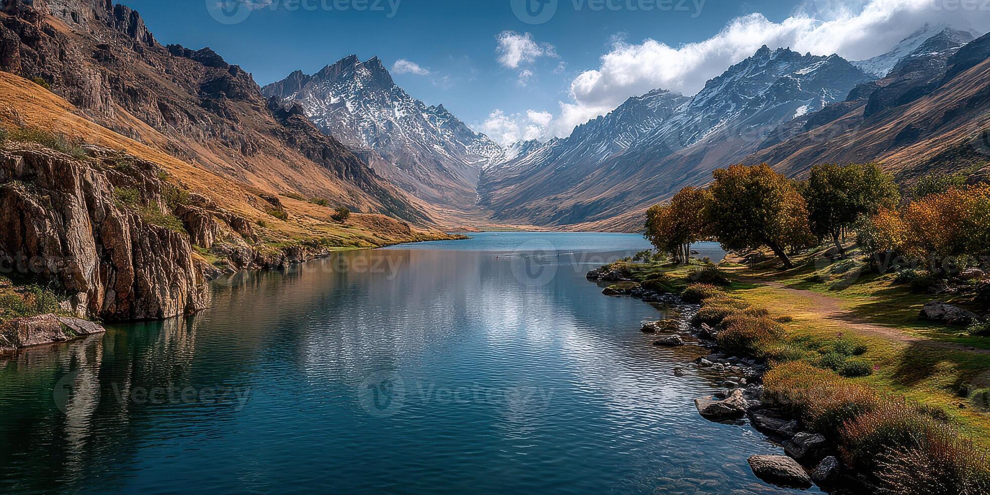 Breathtaking mountain lake landscape reflects majestic peaks at midday with serene waters and lush greenery photo