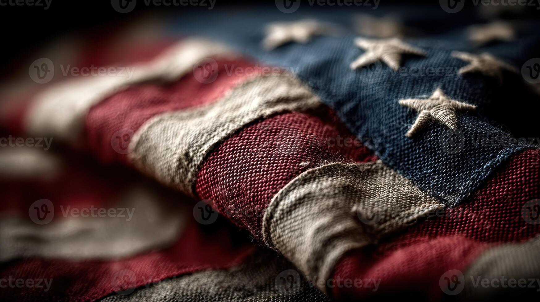 Worn American flag displays history and patriotism through faded colors and textures in a close-up view photo