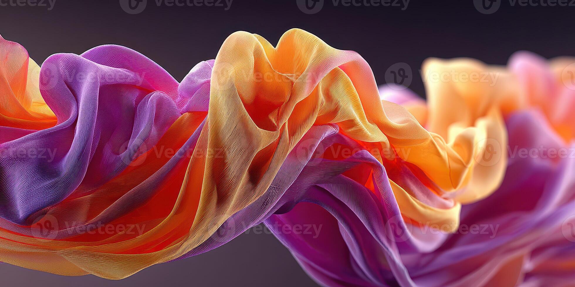 Colorful silk fabric waves in vibrant hues of purple, orange, and yellow create an intriguing visual display photo