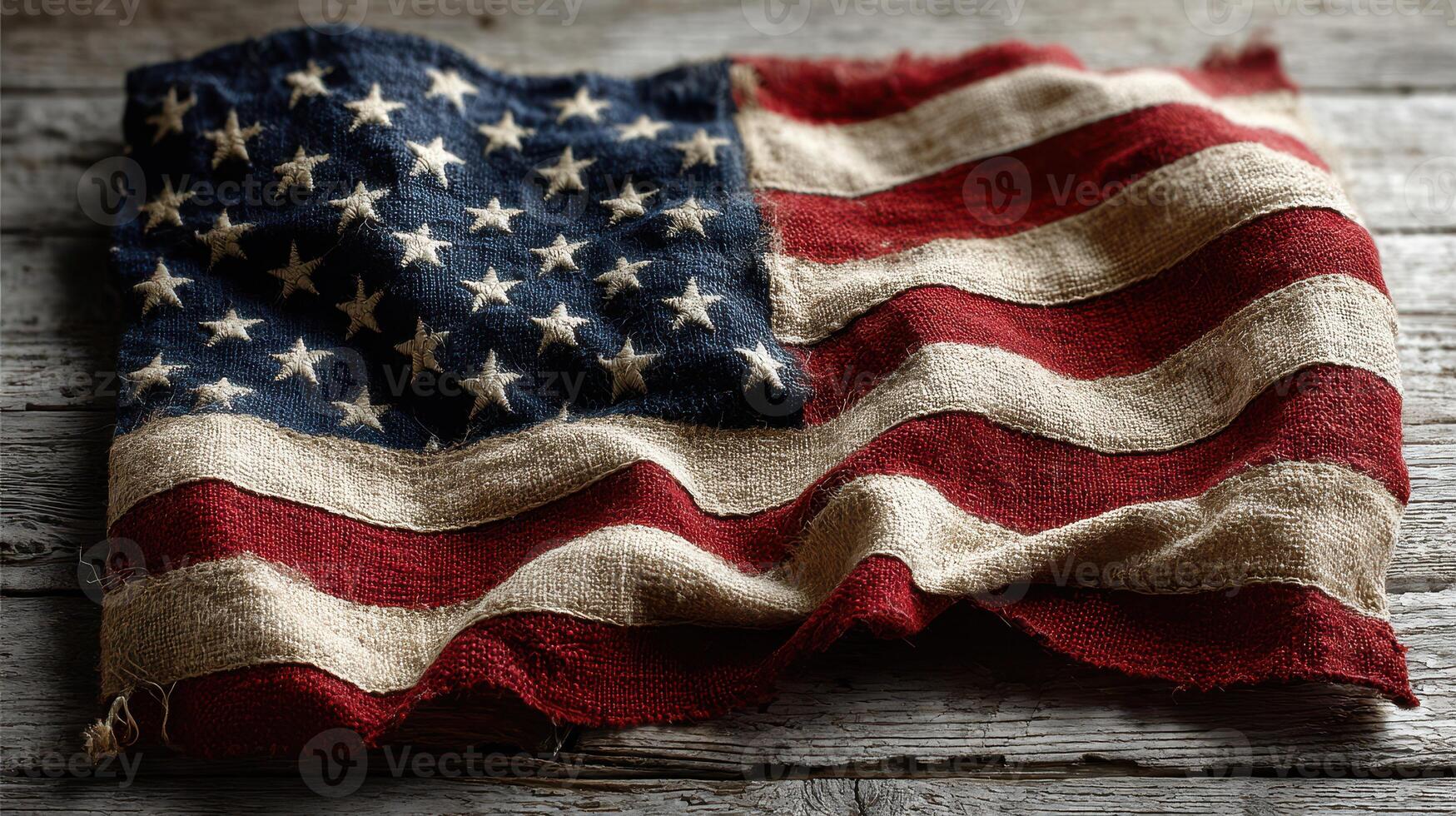 Old American flag draped on rustic wooden surface captures the essence of patriotism and history photo