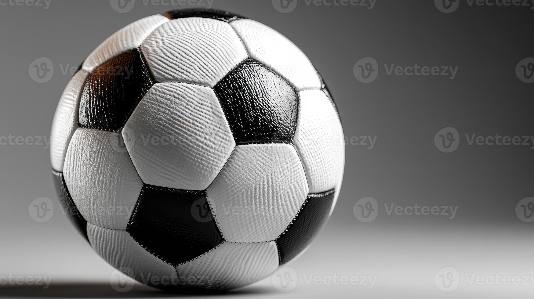 Soccer ball on a neutral background showcasing its textured surface and classic black and white design photo