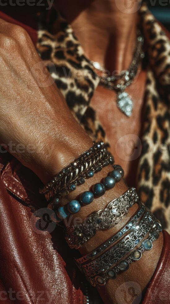 Stylish layered bracelets showcase unique designs under bright sunlight in an urban setting photo