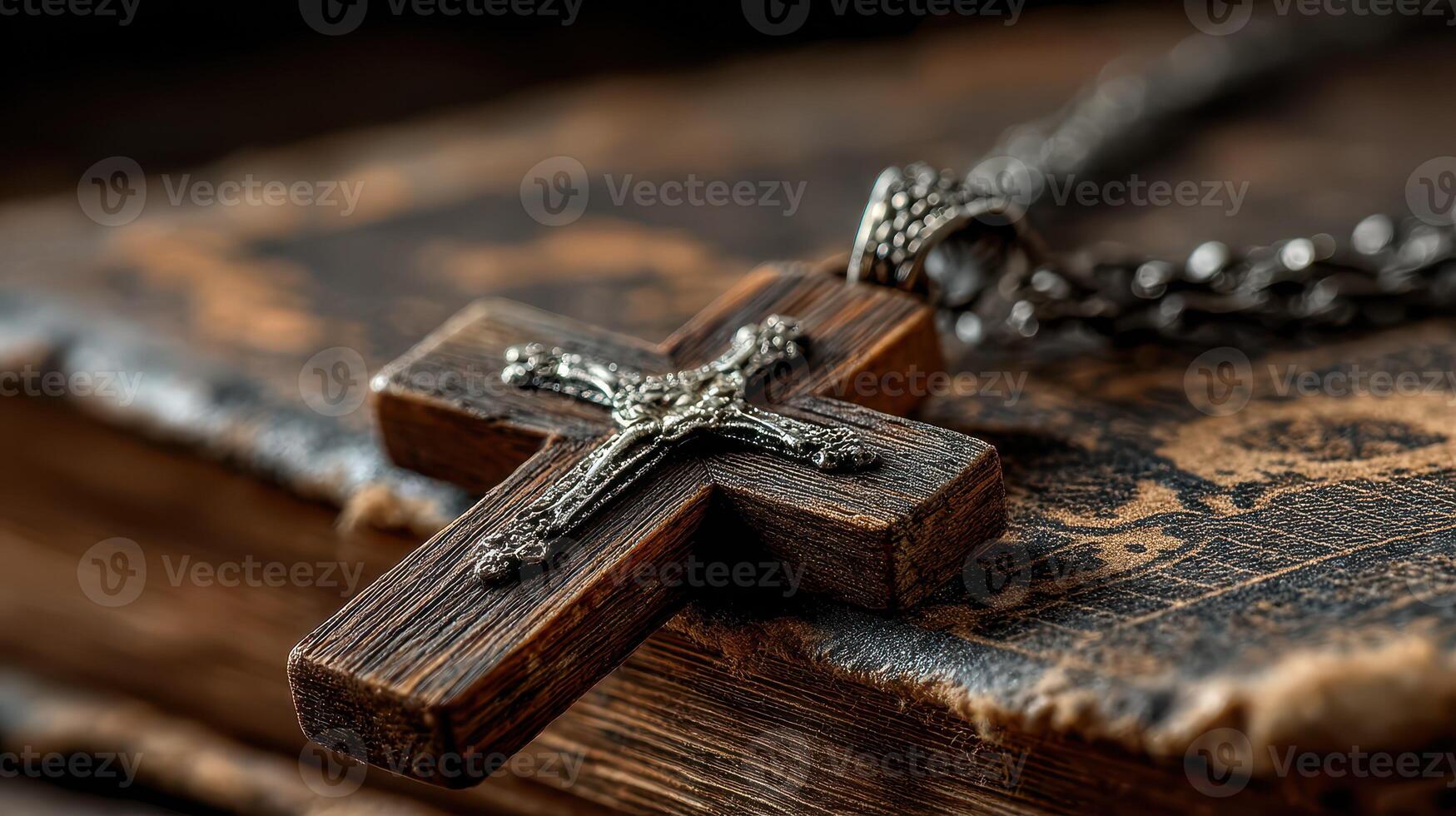Close-up of a wooden cross pendant resting on an antique book highlighting faith and spirituality photo