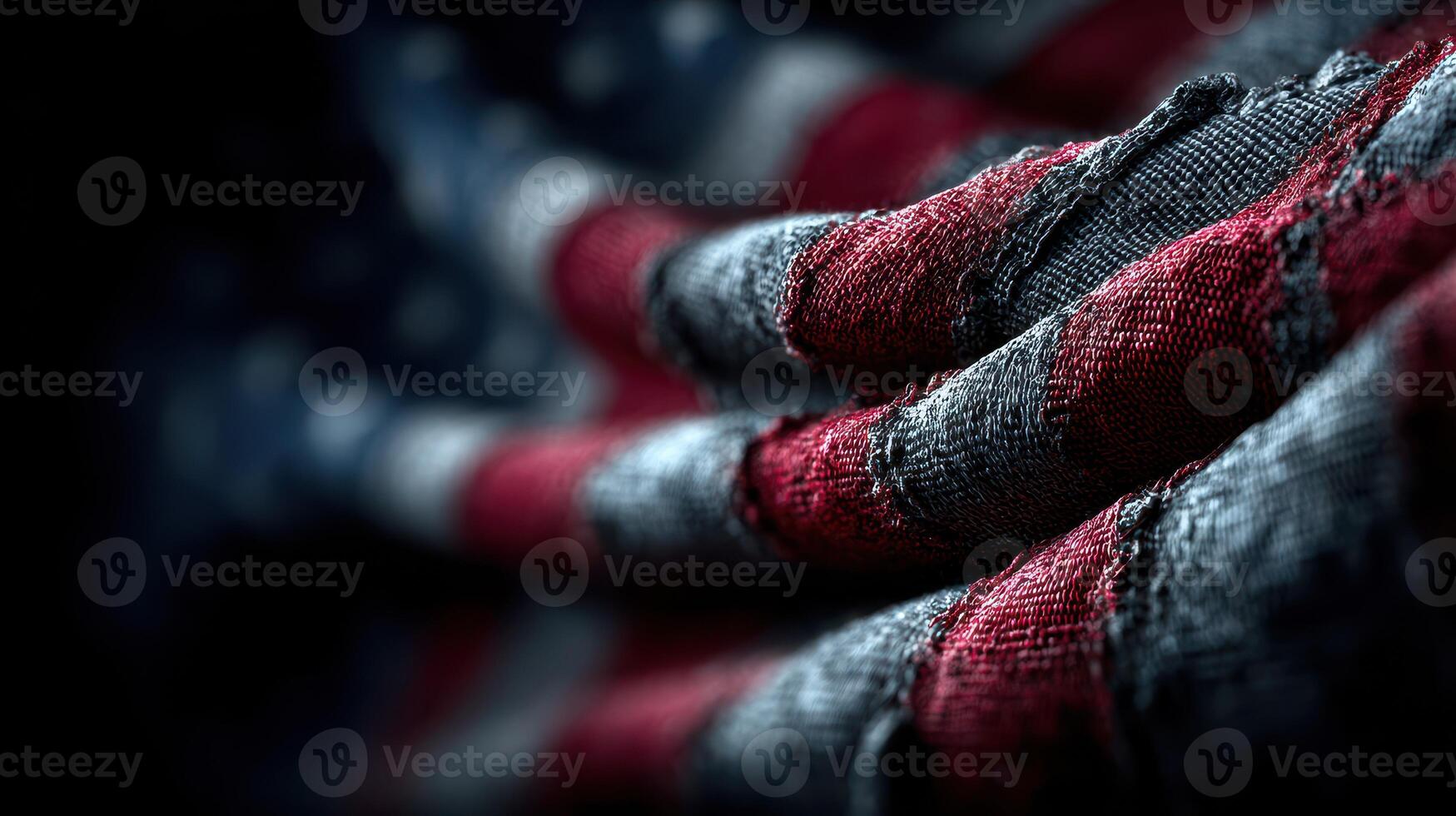 Worn American flag beautifully draped showing rich colors and textures in soft light photo