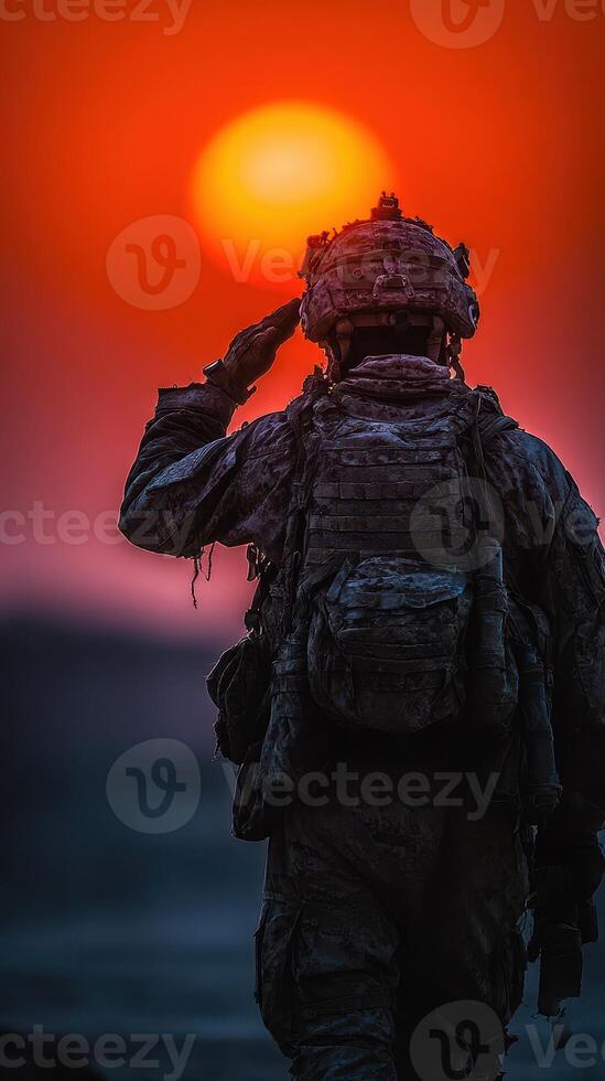 Soldier saluting a sunset while in uniform, showcasing bravery and honor in a serene moment photo