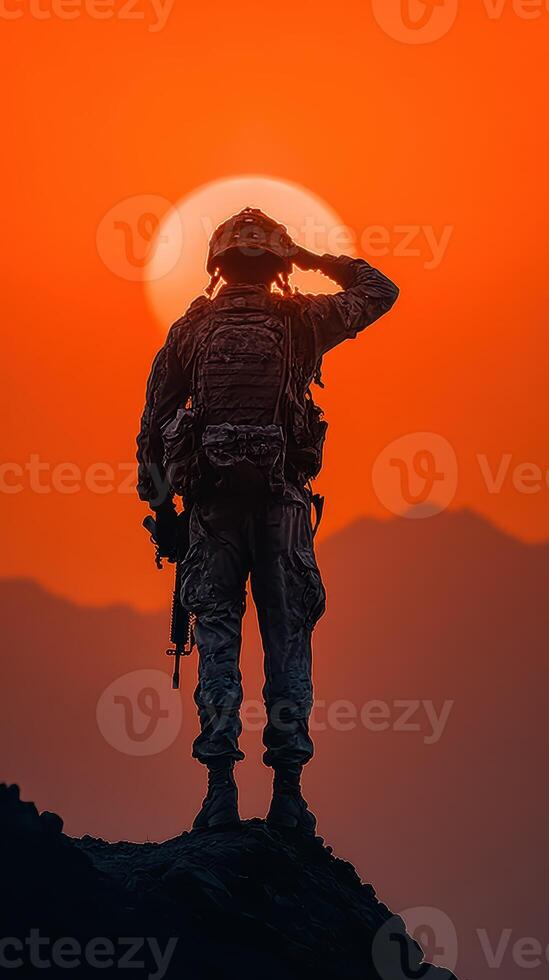 Soldier saluting at sunset with mountains in the background during golden hour photo