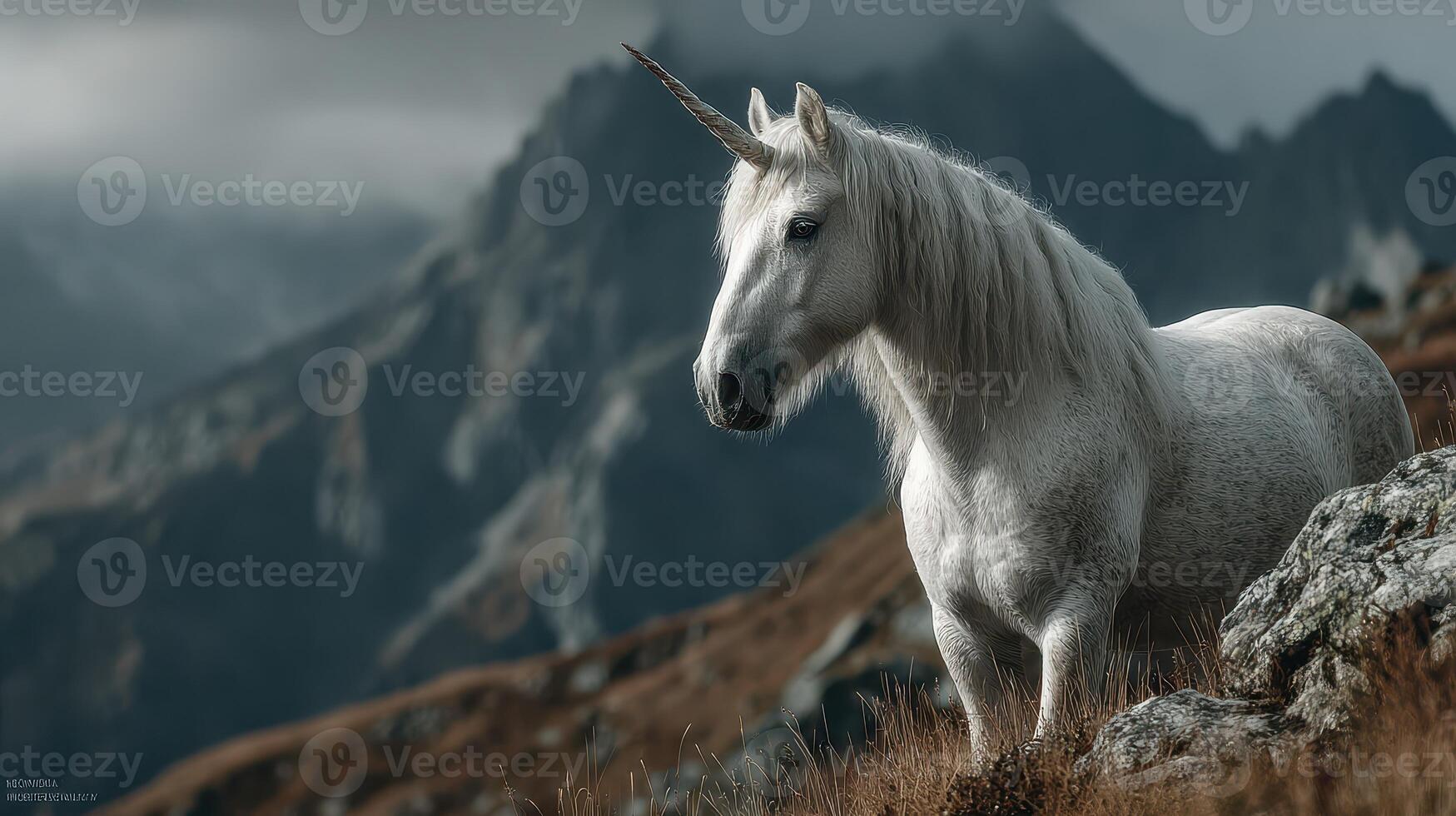 Majestic unicorn standing on rocky terrain with mountains in the background and cloudy skies above at twilight hour photo