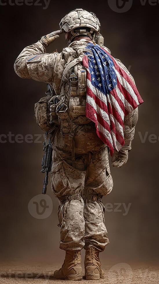 Soldier paying tribute with American flag draped over shoulders in solemn salute at sunset in a desert setting photo