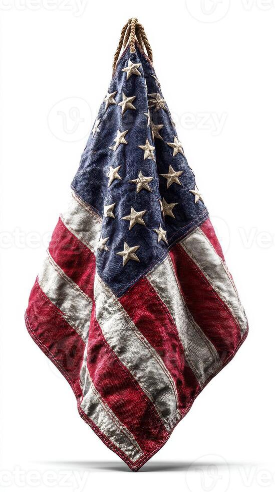 Worn American flag displayed against a neutral background highlighting its faded colors and fabric texture photo