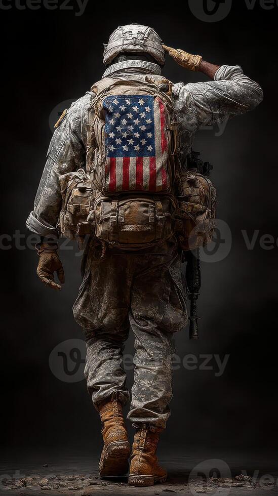 Soldier saluting while adorned in military gear with an American flag backpack in a dramatic setting photo
