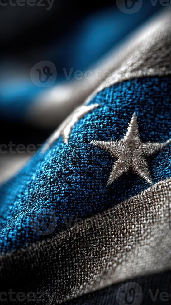 Close-up of a textured flag design highlighting blue and silver colors with intricate stitching details photo