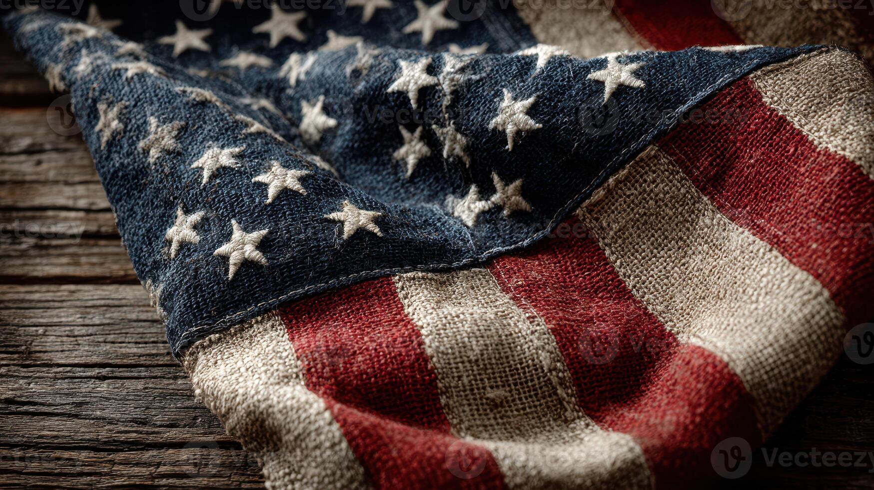 Vintage American flag draped over rustic wooden surface with detailed texture and color contrasts photo