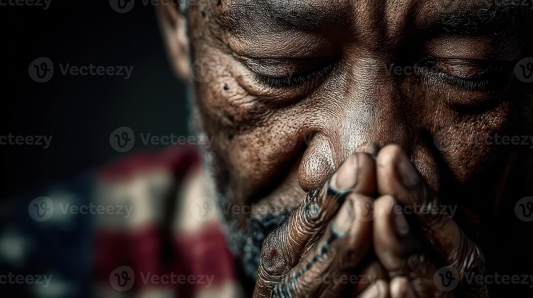 Elderly man with closed eyes praying indoors with hands clasped, captured in soft lighting showcasing deep emotions photo
