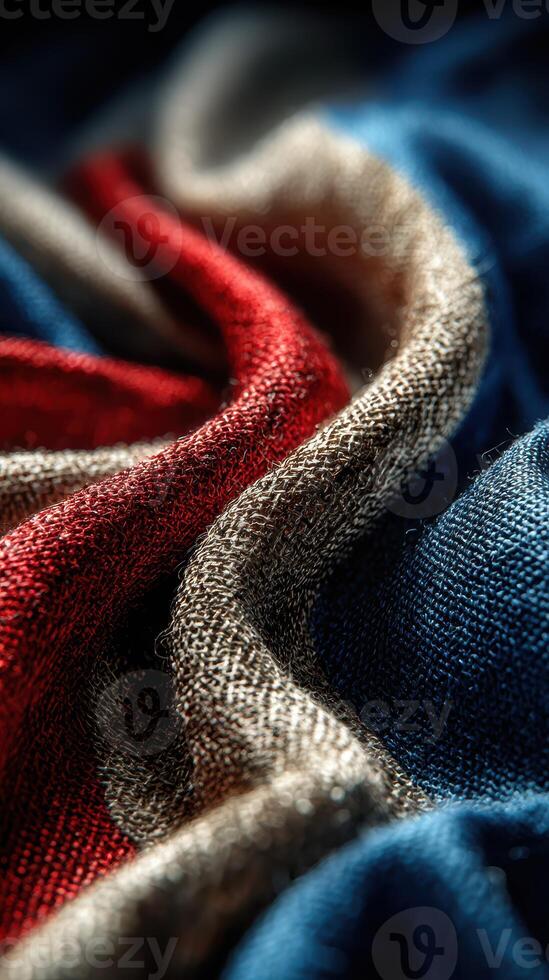 Colorful fabric textures create an abstract art piece with vibrant red, blue, and neutral tones in soft folds photo