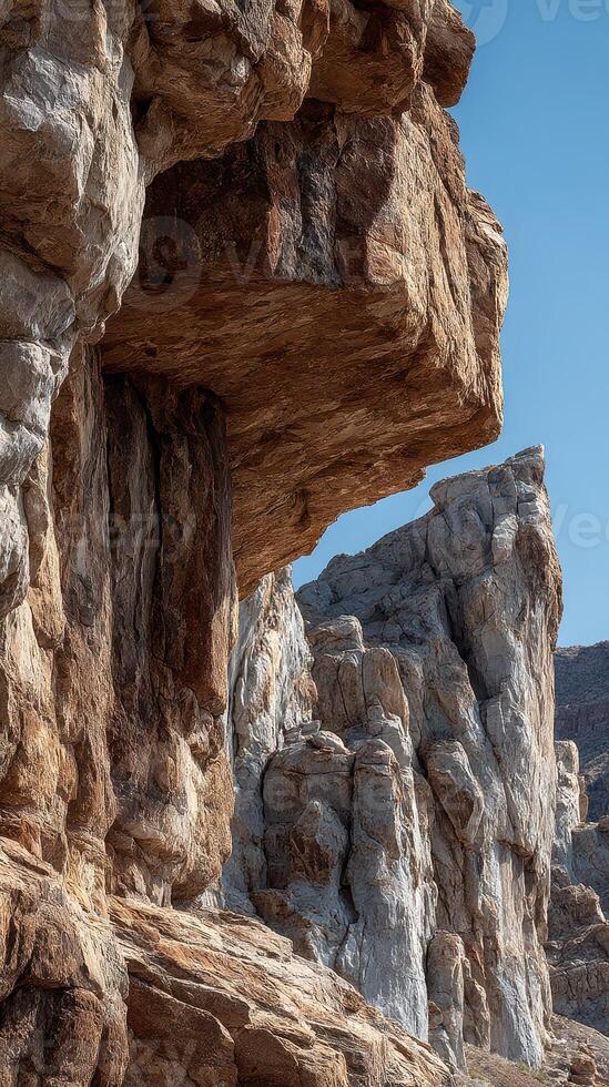 Rock formations rise dramatically under clear blue sky showcasing natural beauty and geological wonders in a serene outdoor setting photo
