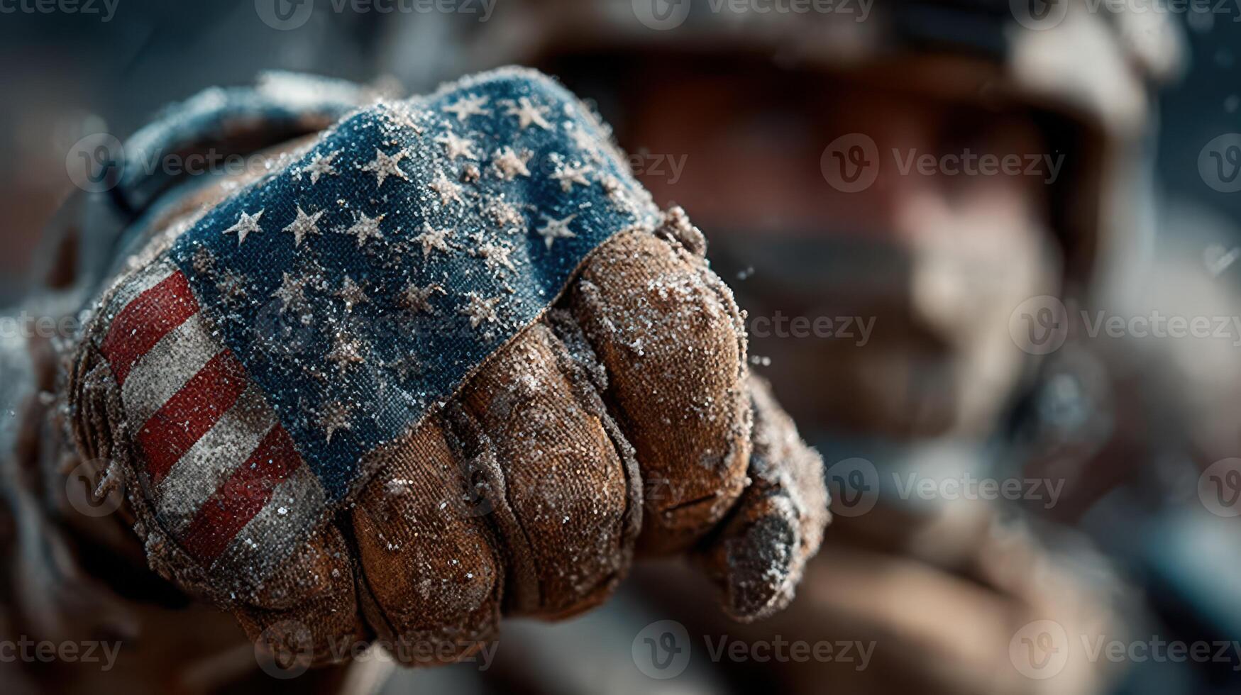 Soldier stands ready, showing a weathered glove adorned with the American flag during a harsh winter environment in a combat scenario photo