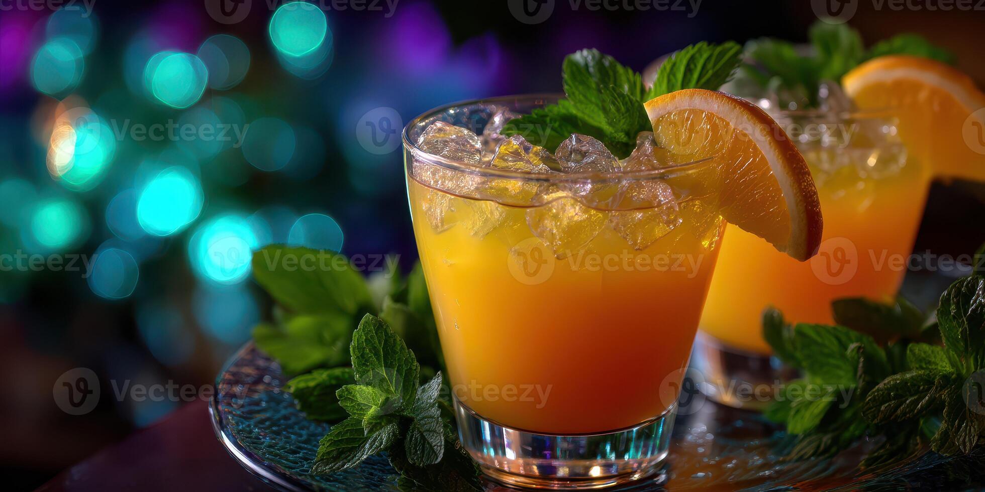 Refreshing tropical cocktails served with mint and orange during a vibrant evening gathering photo