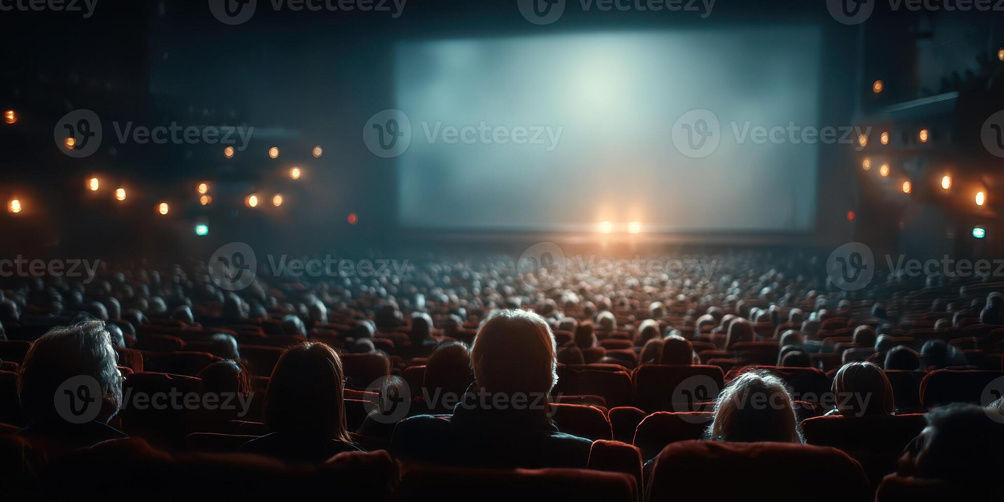 Large audience eagerly awaits the start of a captivating movie at an elegant theater during a bustling evening photo