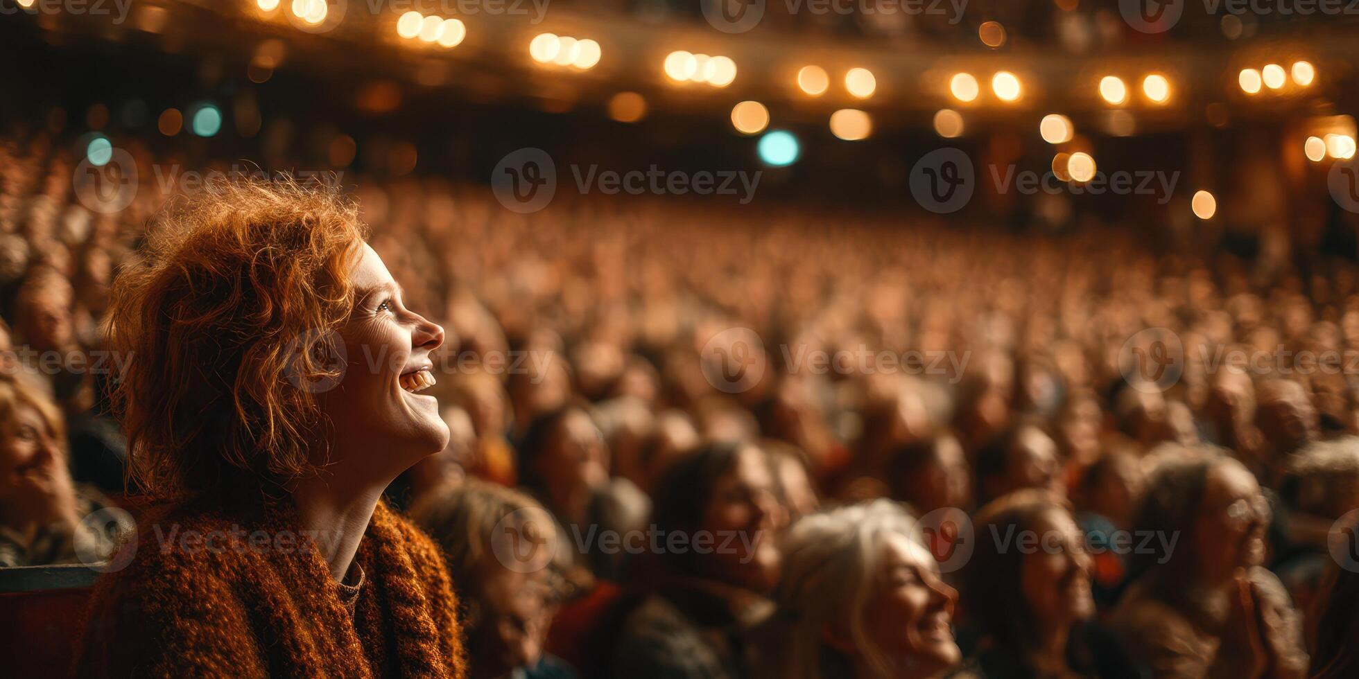 Enthusiastic audience enjoying a live performance at a theater with a captivating atmosphere during the evening photo