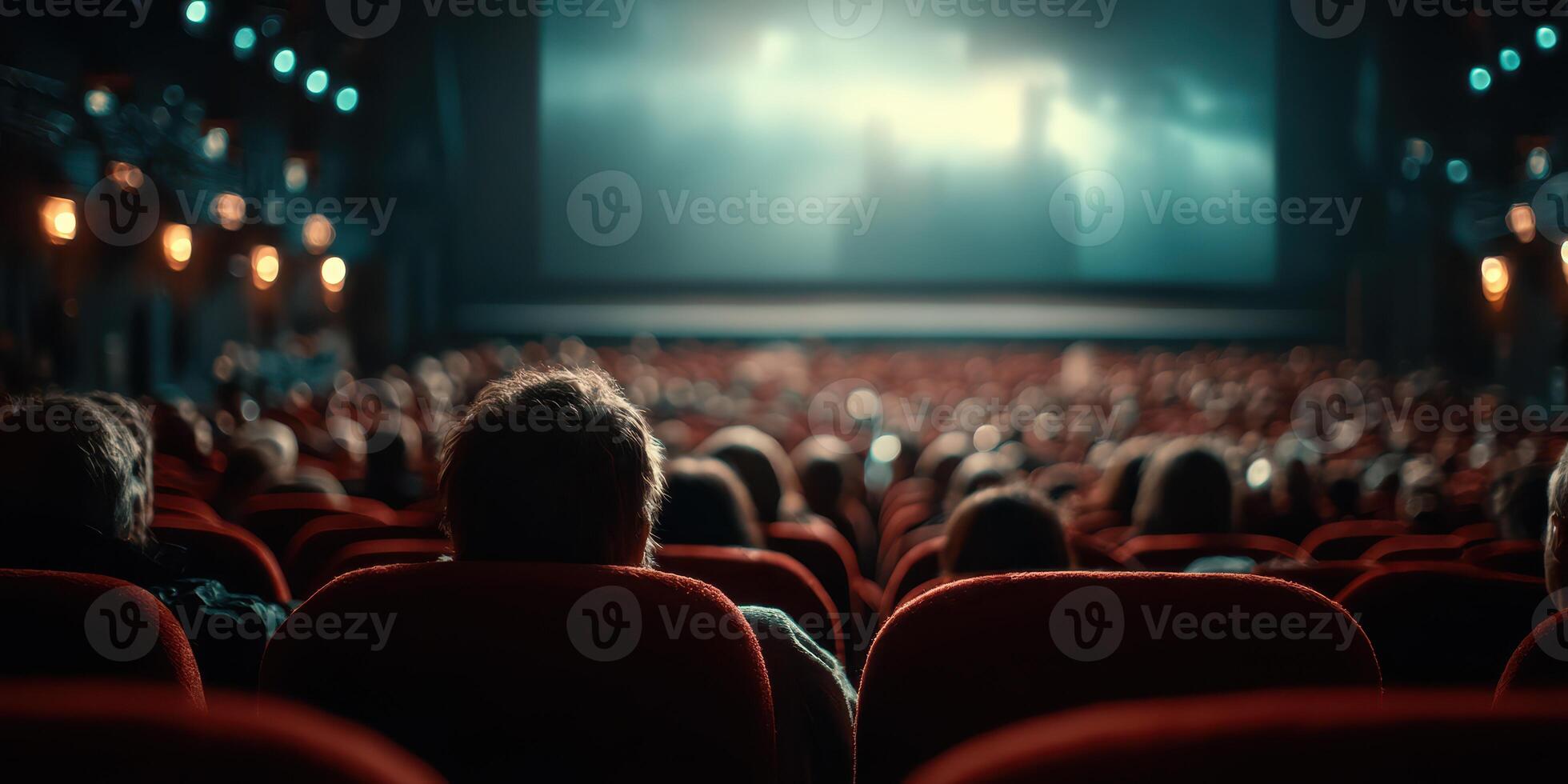 Crowded cinema with viewers watching a film during an evening screening in a vintage theater photo