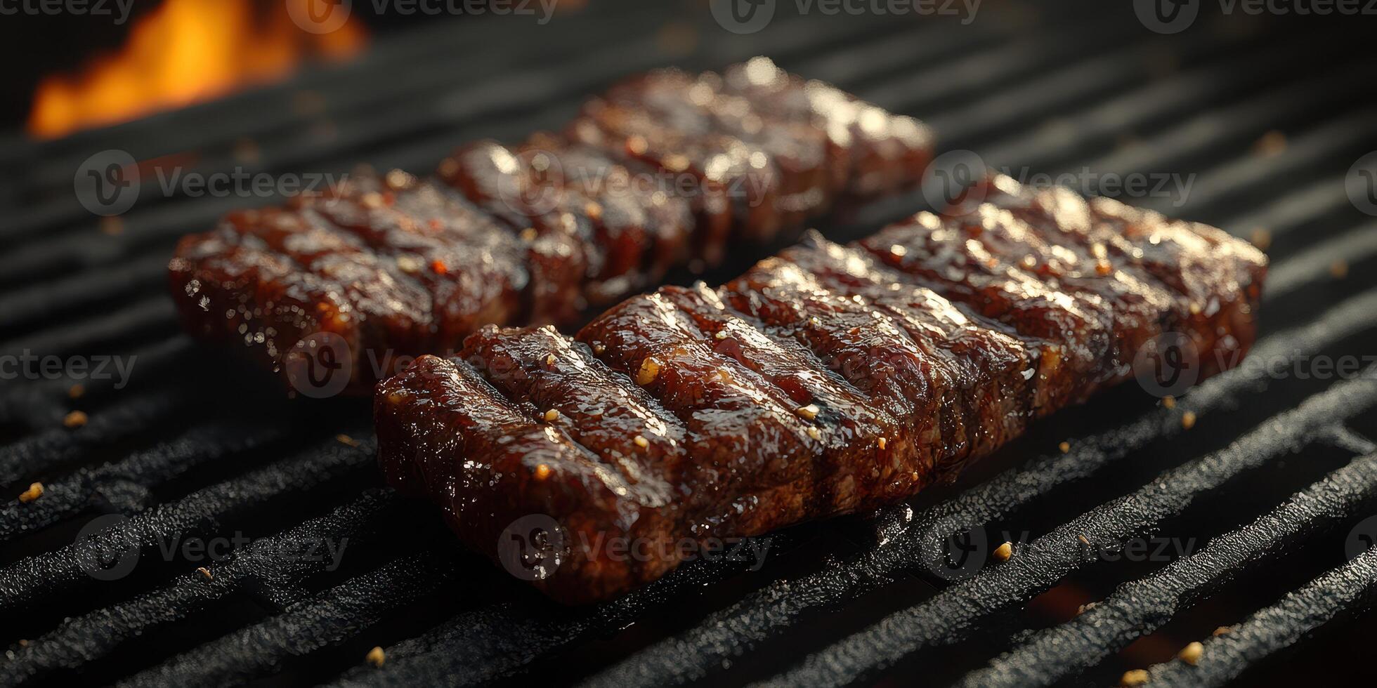 Delicious grilled steak sizzling over hot barbecue coals in a backyard setting during a summer afternoon gathering photo