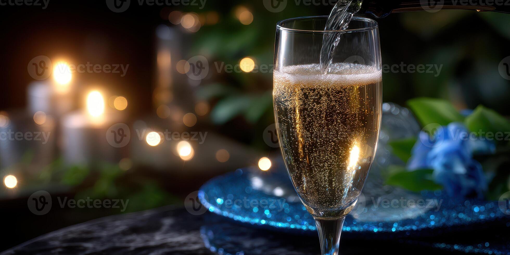Bubbly drink being poured into a crystal glass at a romantic evening gathering with warm candlelight photo