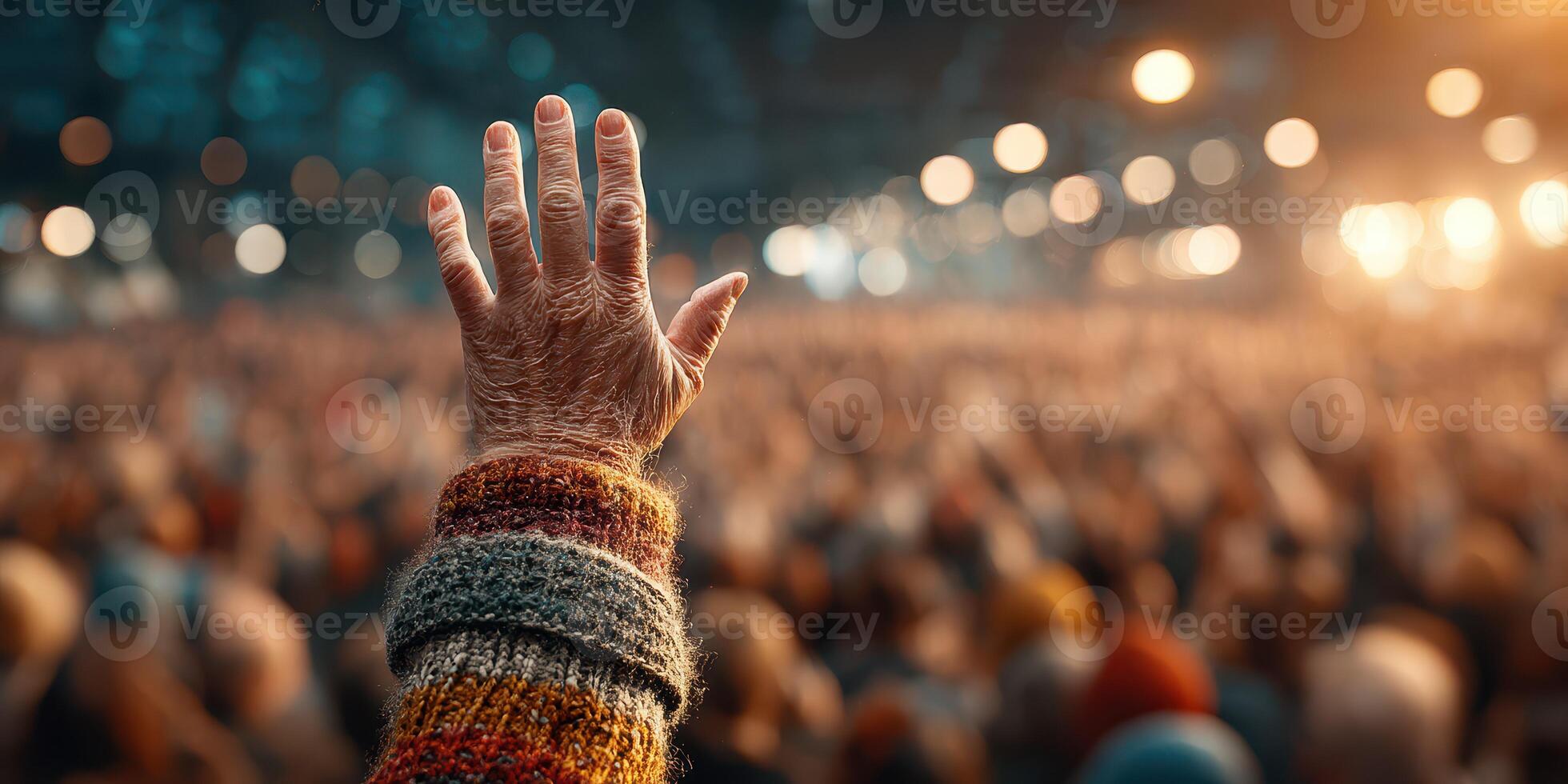 Crowd gathered in support with raised hands at a lively event photo