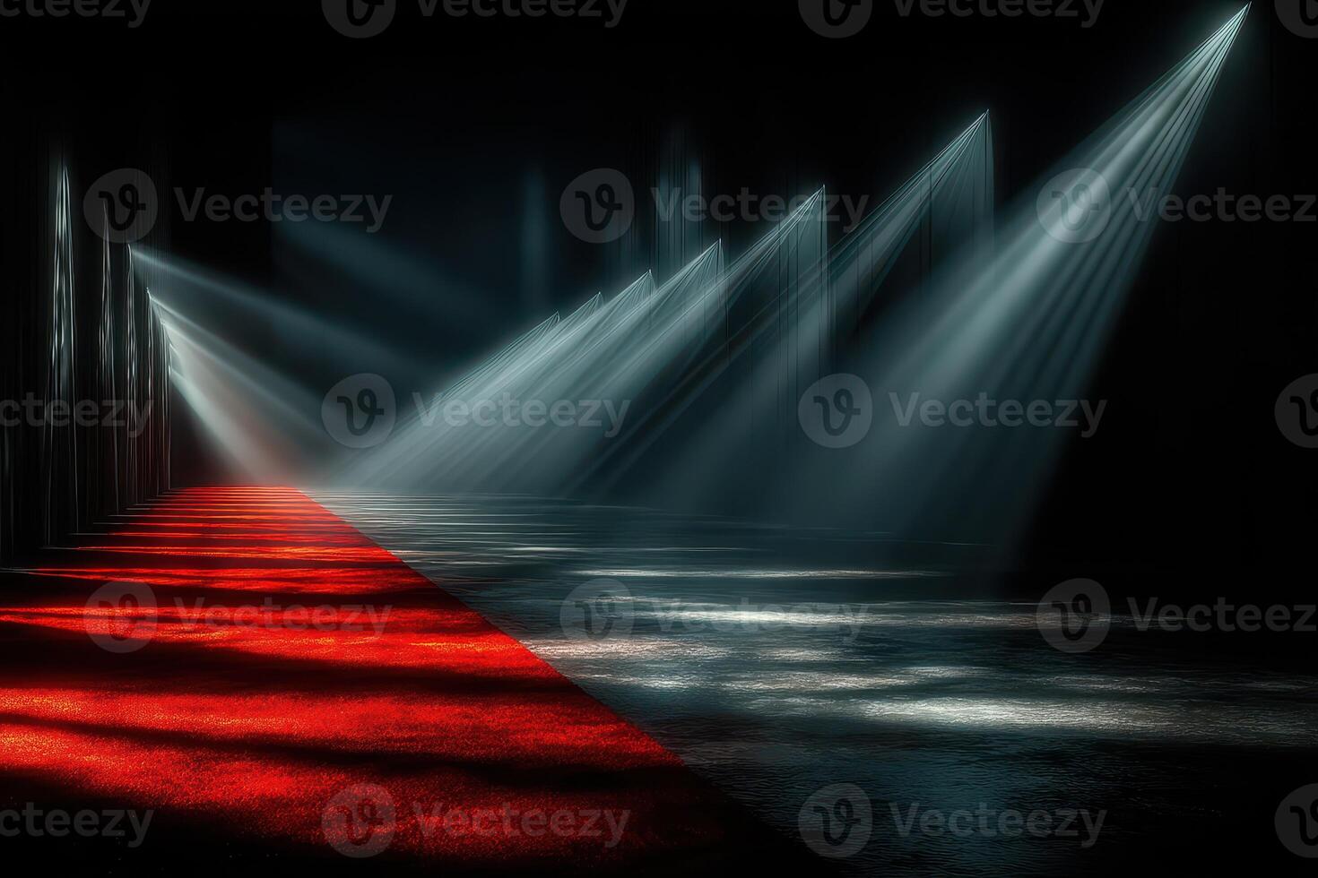 Light beams illuminate a red carpet path in a dramatic dark venue setting for an exclusive event or performance photo