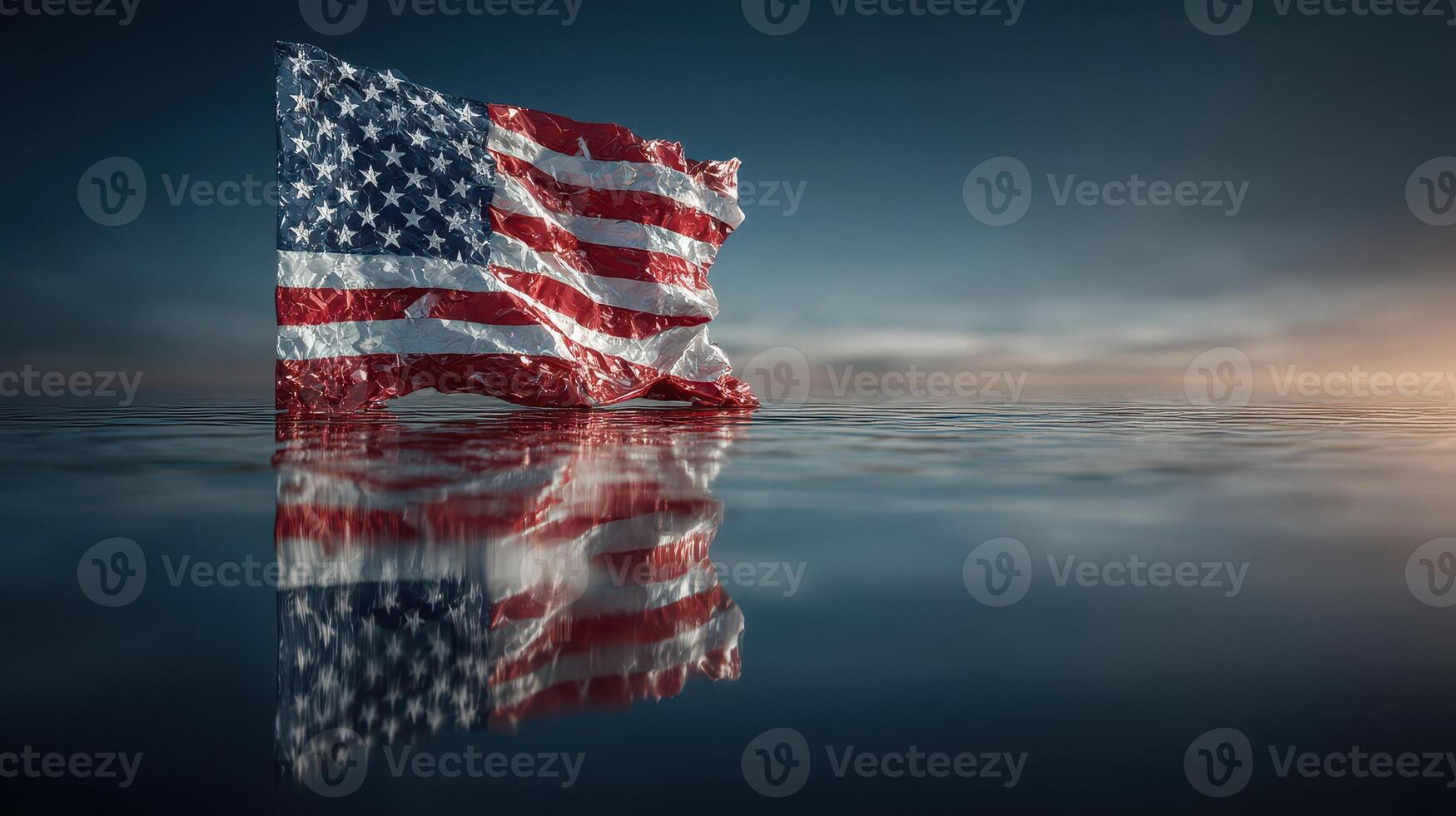 Waving American flag reflects on calm waters at sunset in a serene coastal setting photo
