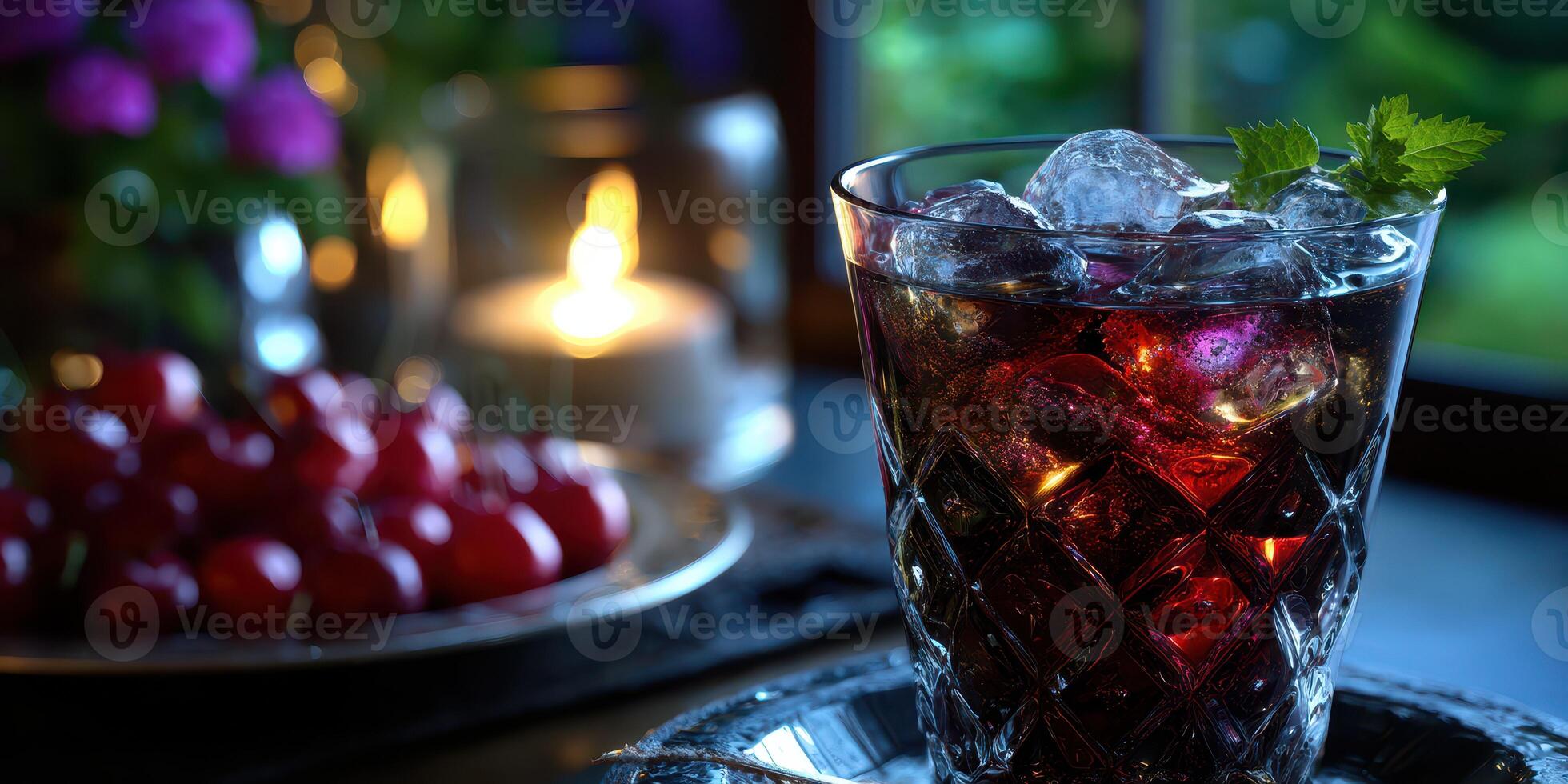 Refreshing drink with ice and mint in a cozy setting during evening hours with candles and fresh cherries photo