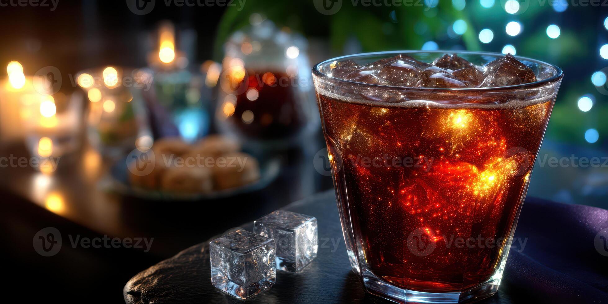 Refreshing drink with ice in a cozy setting featuring candles and snacks during evening gathering photo