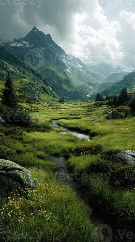 Mountain valley landscape showcasing a serene stream amidst lush greenery and dramatic cloudy skies in an alpine region photo
