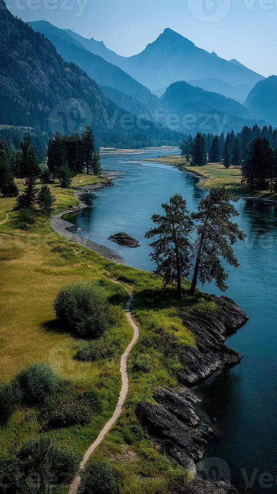 Scenic river winding through mountains and forests during a clear day in a natural landscape photo