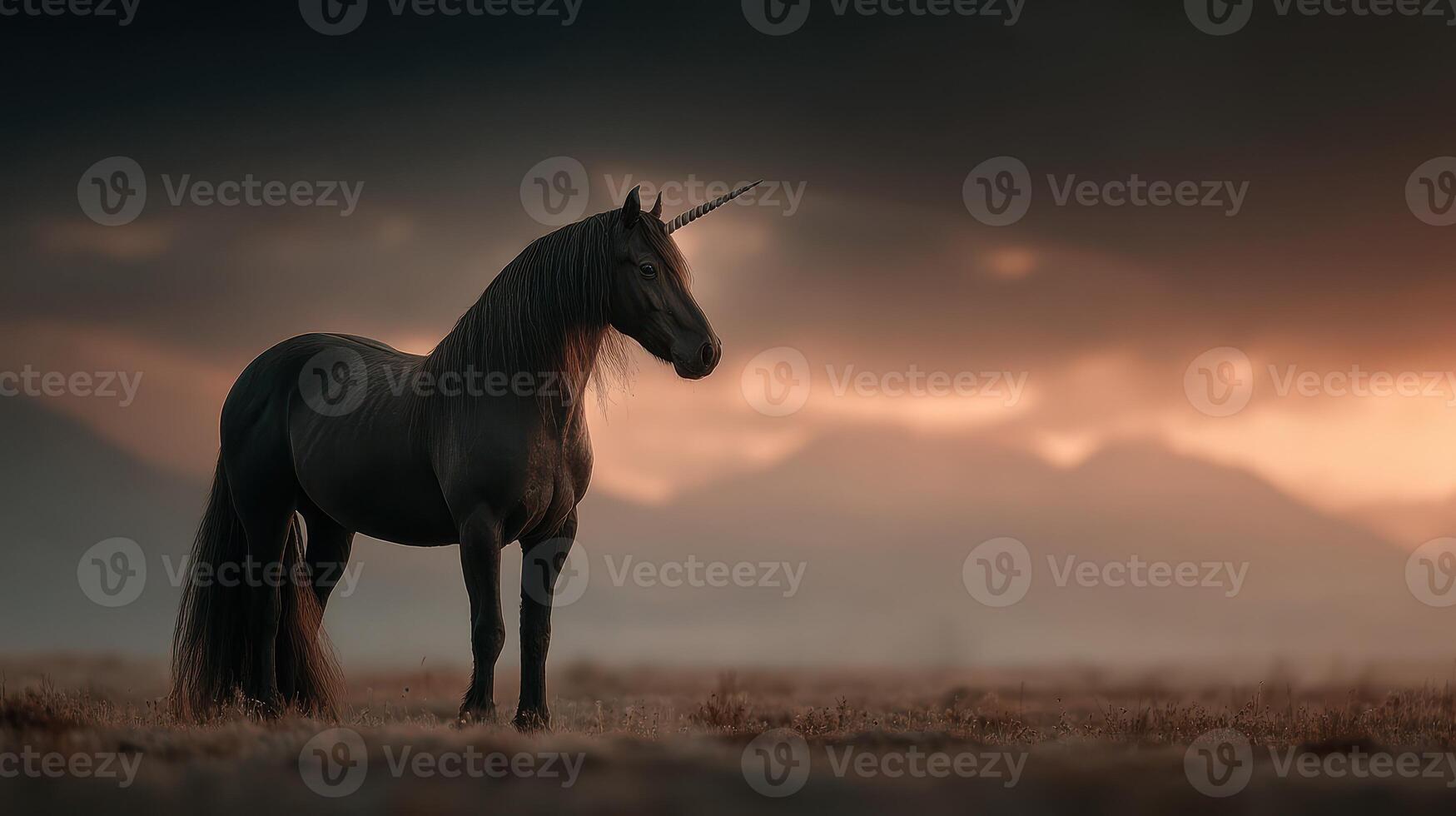Majestic black unicorn standing in a serene landscape under a dramatic sky during twilight hours photo