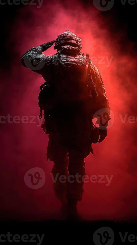 Soldier saluting in a misty atmosphere during a dramatic backdrop at dusk photo