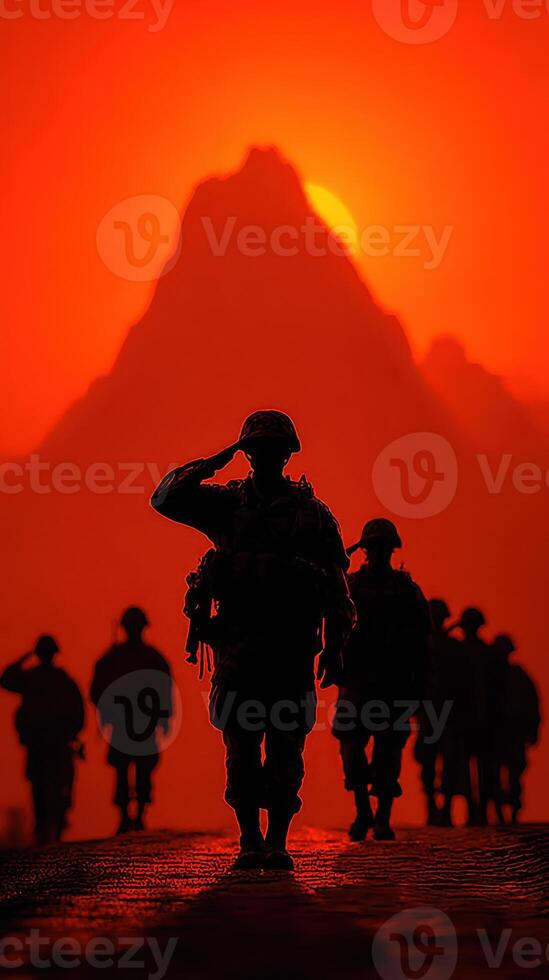 Silhouetted soldiers salute against a vibrant sunset backdrop in mountainous terrain, showcasing camaraderie and respect photo