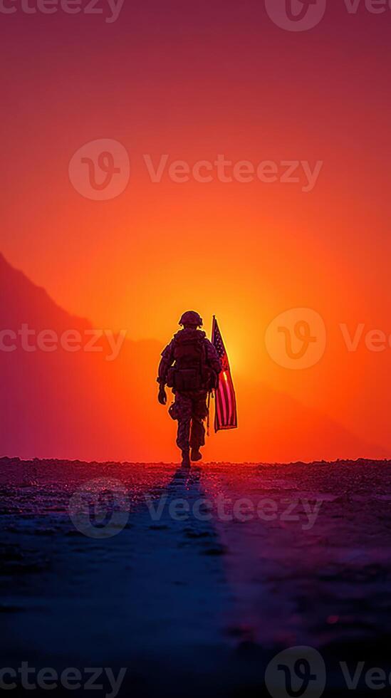 Soldier walks with American flag at sunset in a dramatic landscape highlighting courage and patriotism photo