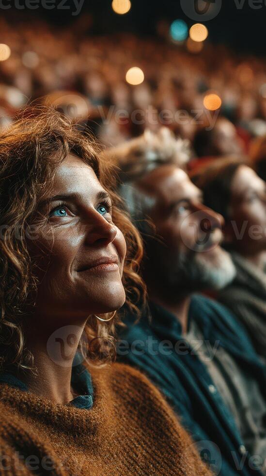 Audience watches intently during a performance in a theater setting, showcasing diverse emotions and engagement photo
