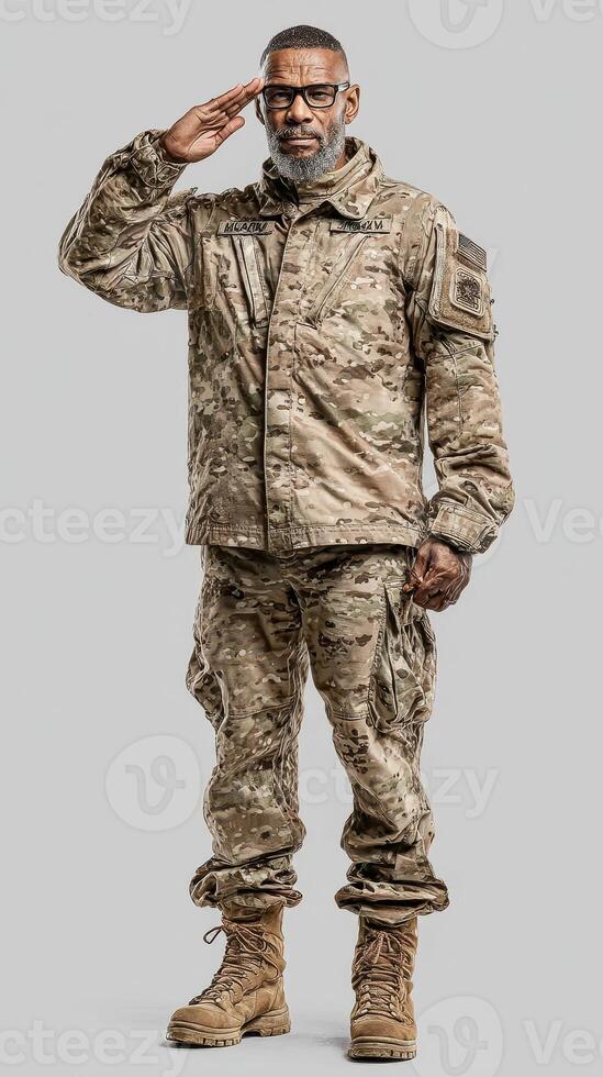 Military personnel in camouflage uniform saluting with respect in a neutral setting photo