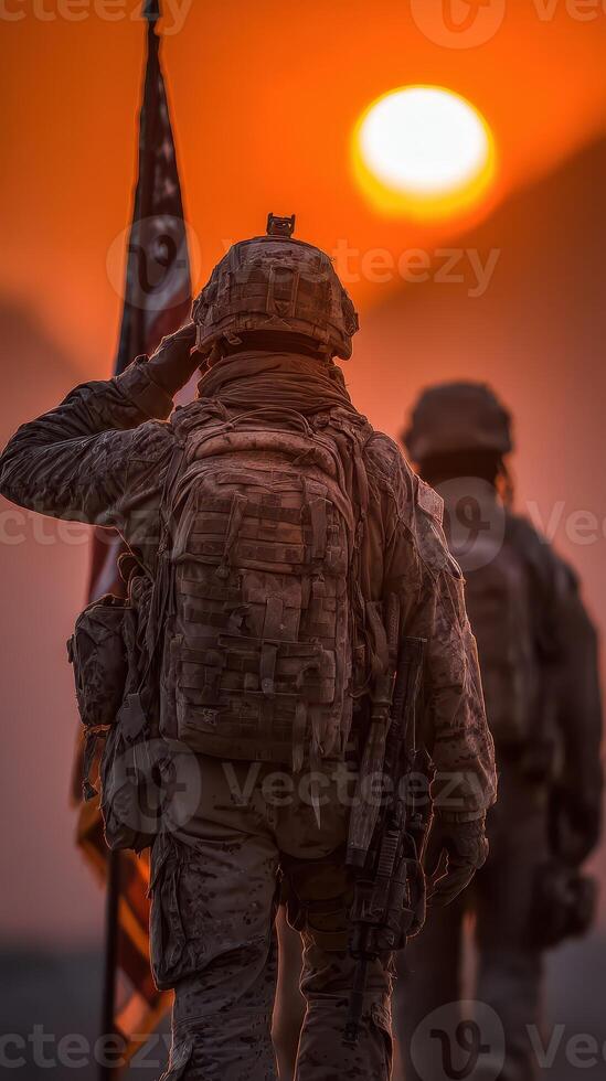 Soldiers salute the flag during a sunset in a desert landscape photo