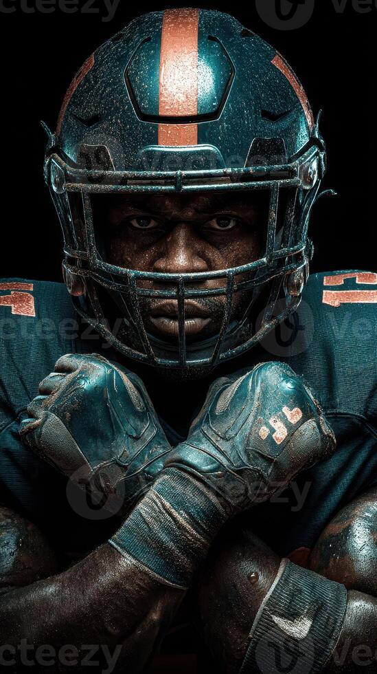 Football player showcasing determination in dramatic lighting during a game preparation moment at a stadium photo