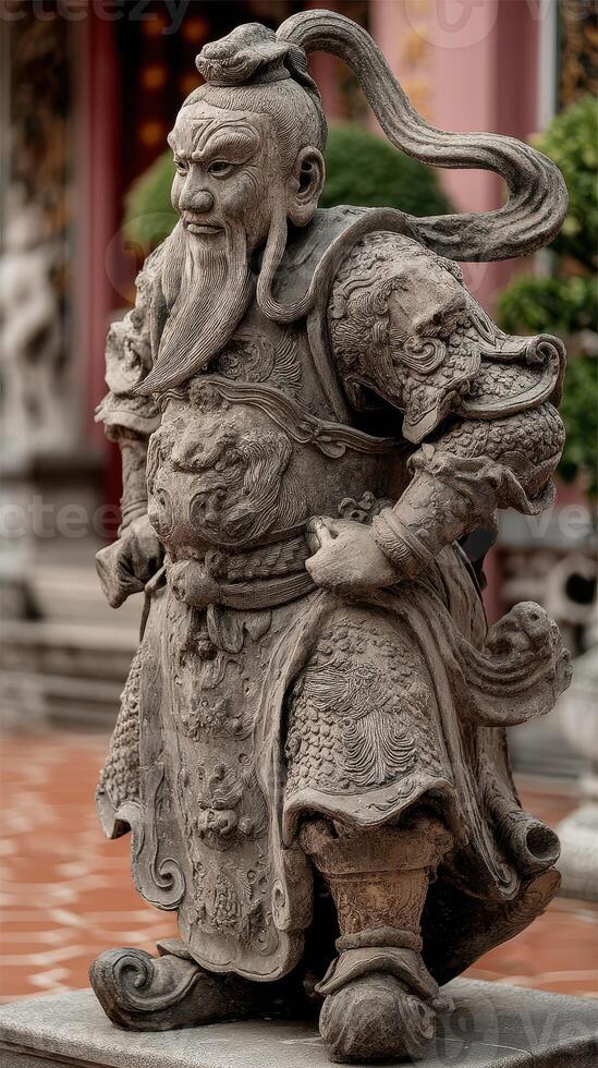 Stone warrior statue stands proudly in a temple courtyard surrounded by lush greenery and ornate architecture photo